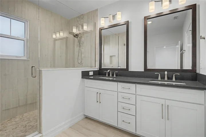 Third-level primary en-suite featuring double sinks and a spacious walk-in shower.
