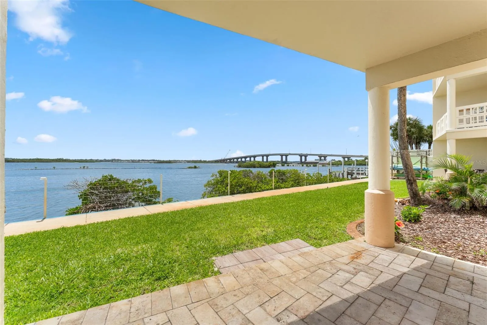 Beautifully pavered lanai with a view right on the water.