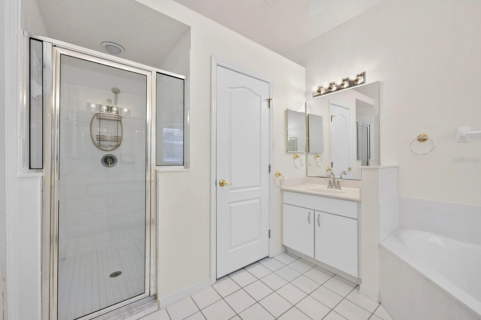 The PRIVATE EN SUITE BATH features dual vanities, a relaxing garden tub, a separate step-in shower with a NEWER LIGHT (2023), and a private water closet.
