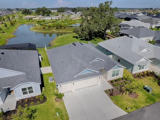 Front of house with pond in back yard, room for pool