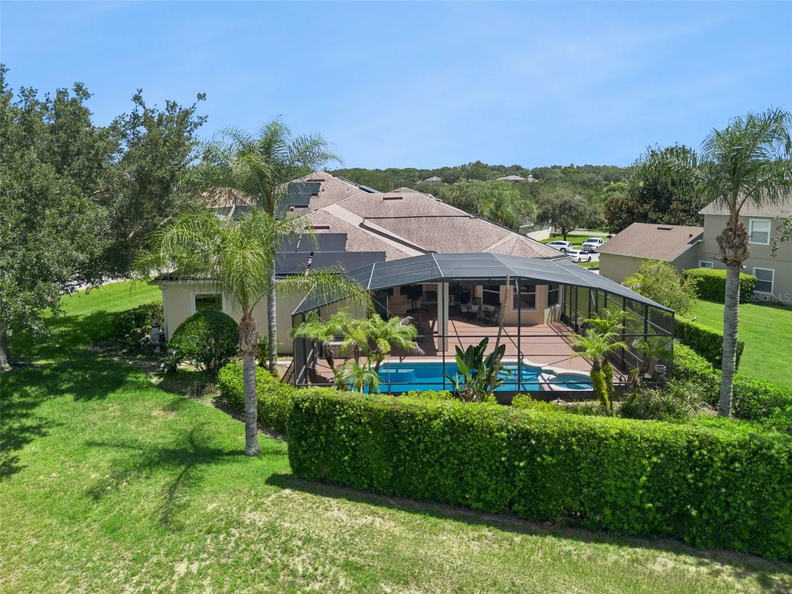 Lush landscaping surrounding the screened lanai