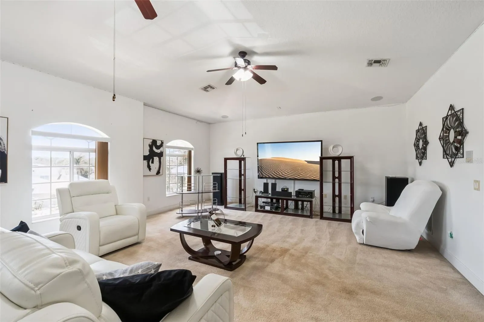 Upstairs loft with high ceilings and arched windows