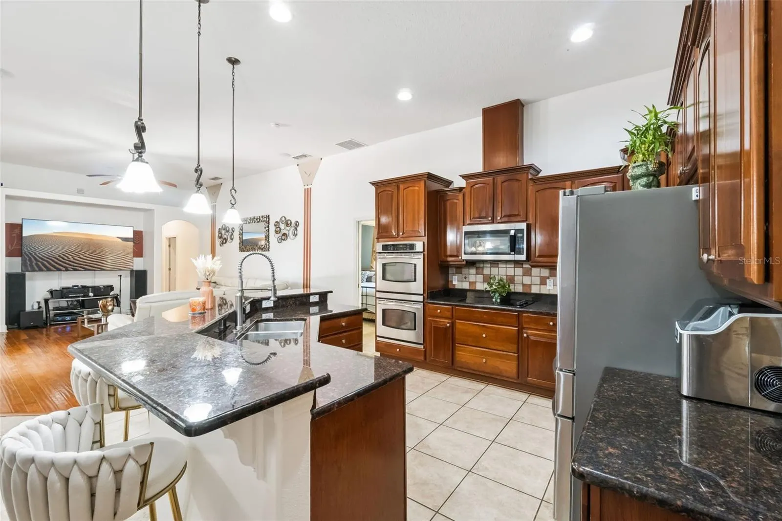 Kitchen island with granite counters and pendant lighting