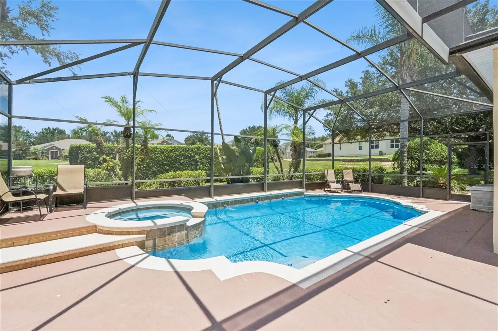 Screened solar heated pool with in ground spa
