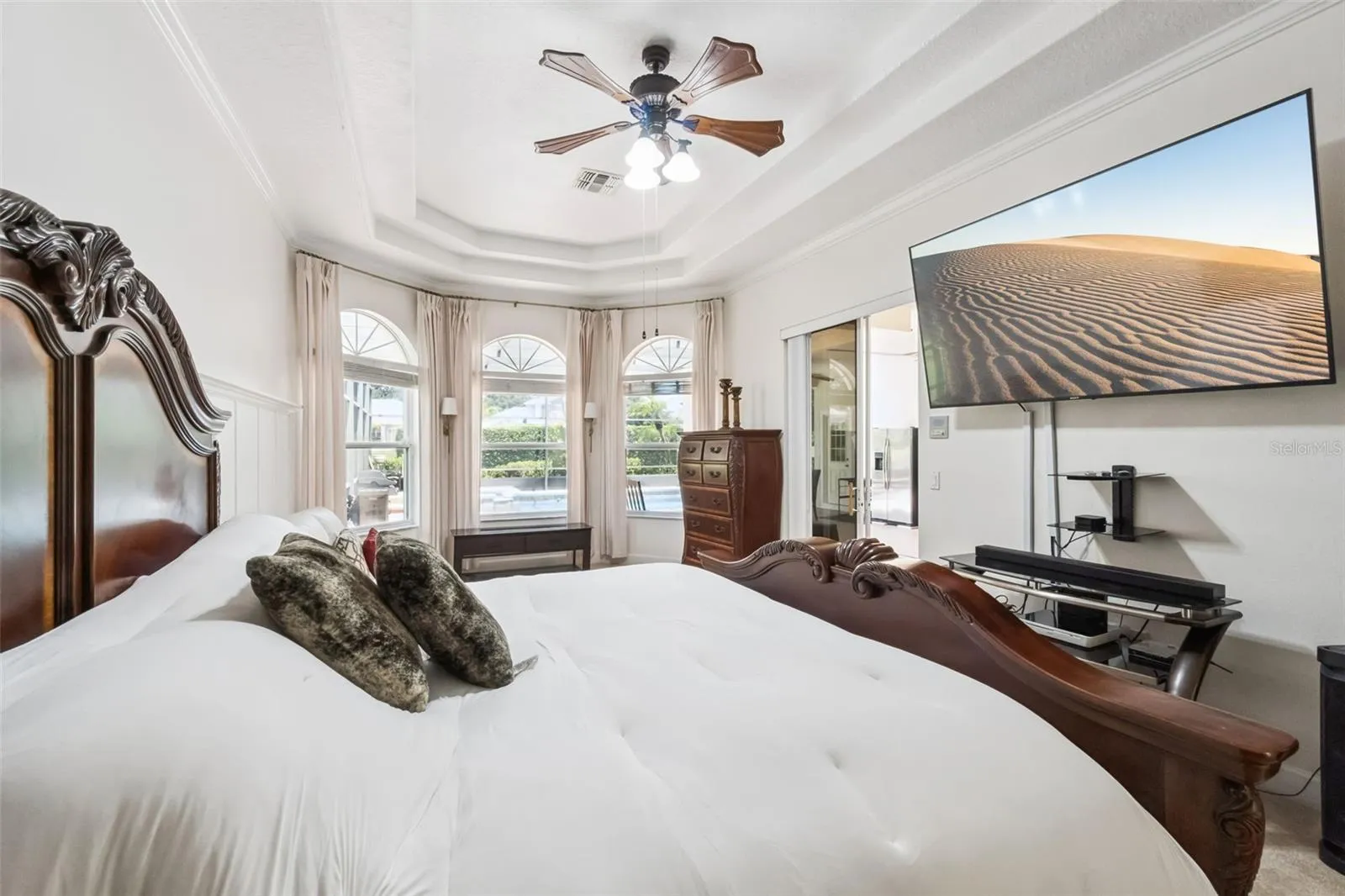 Primary suite with coffered ceiling and bay window