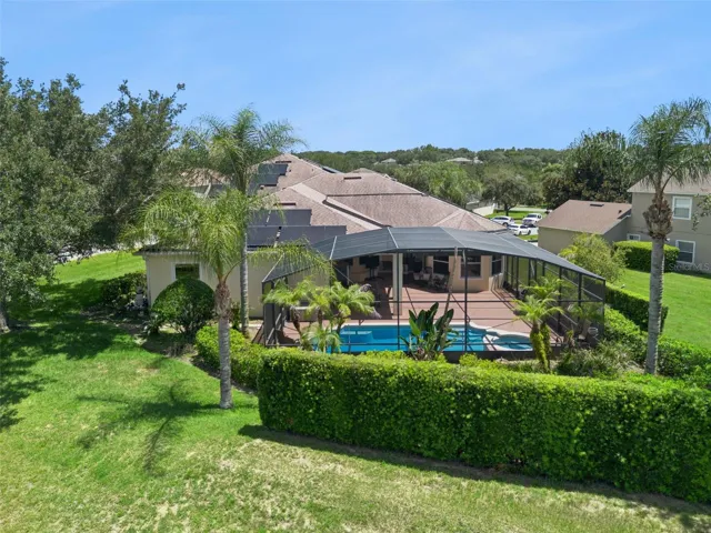 Lush landscaping surrounding the screened lanai