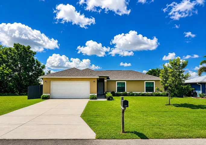 214 SE 1st Ter Cape Coral, FL 33990 - Front lawn and Garage