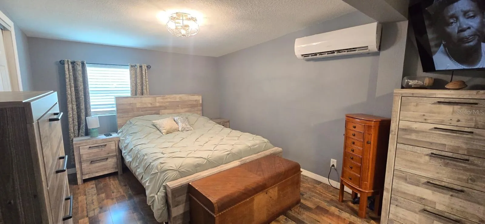 The primary bedroom displaying vinyl, plank flooring.