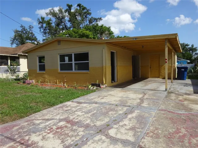 Front view of home.  1 car carport and parking pads.