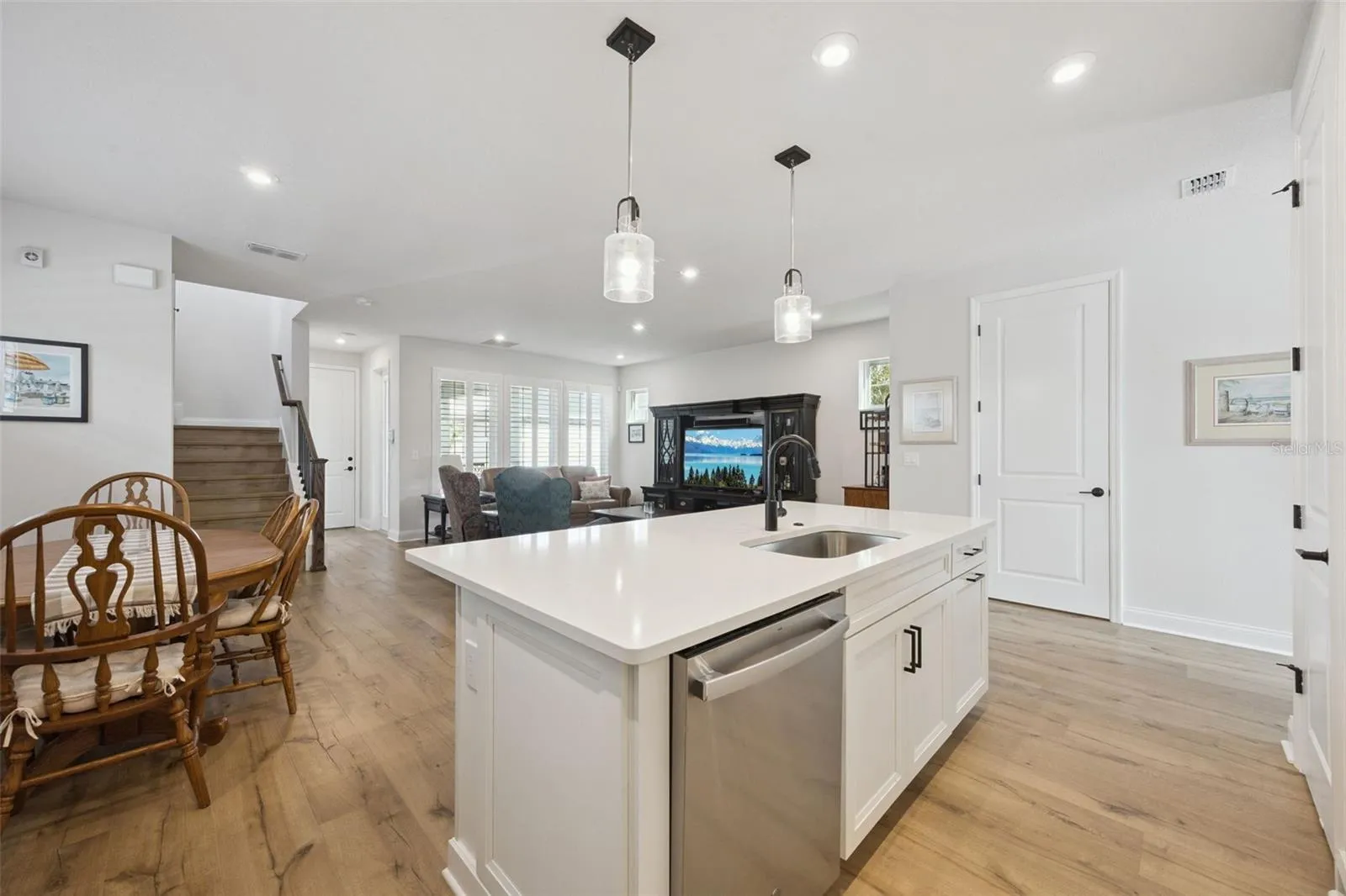 Kitchen Island features a Single Bowl Stainless Sink (a must!) highlighted by a Matte Black Moen Faucet and Coordinating Pendant Lighting.