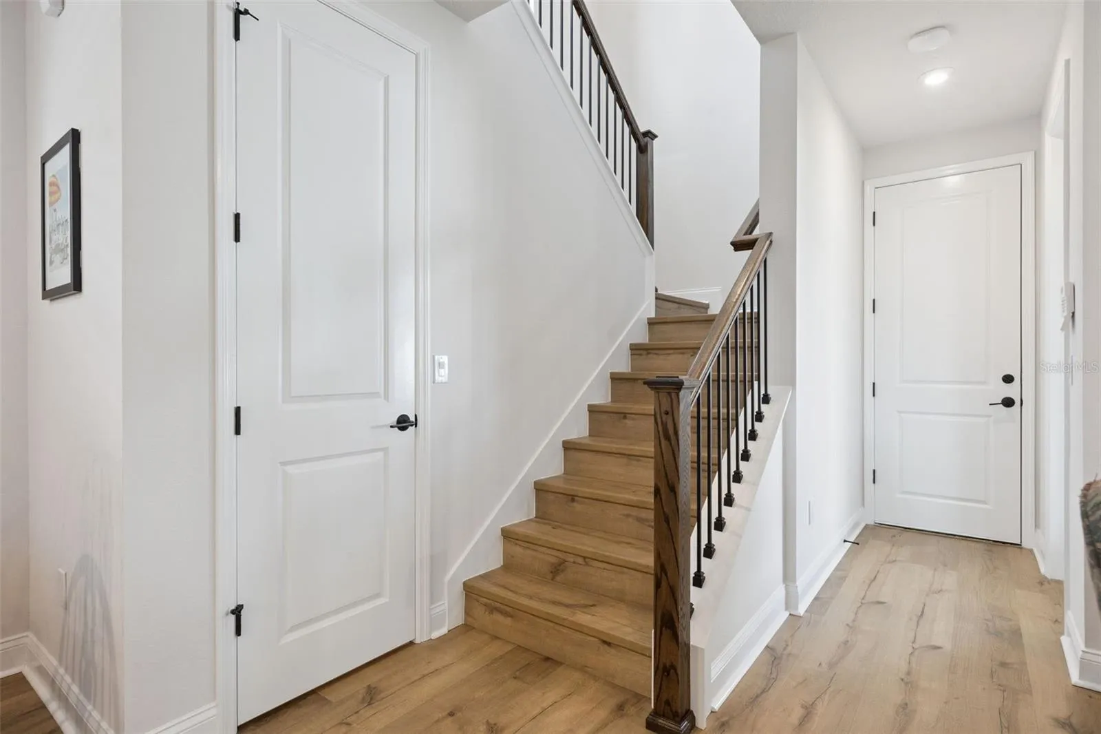 Pantry, Stairway and Entry door to the 3 car garage, Entry door to the Covered Porch. 5-1/4 baseboards throughout the home.