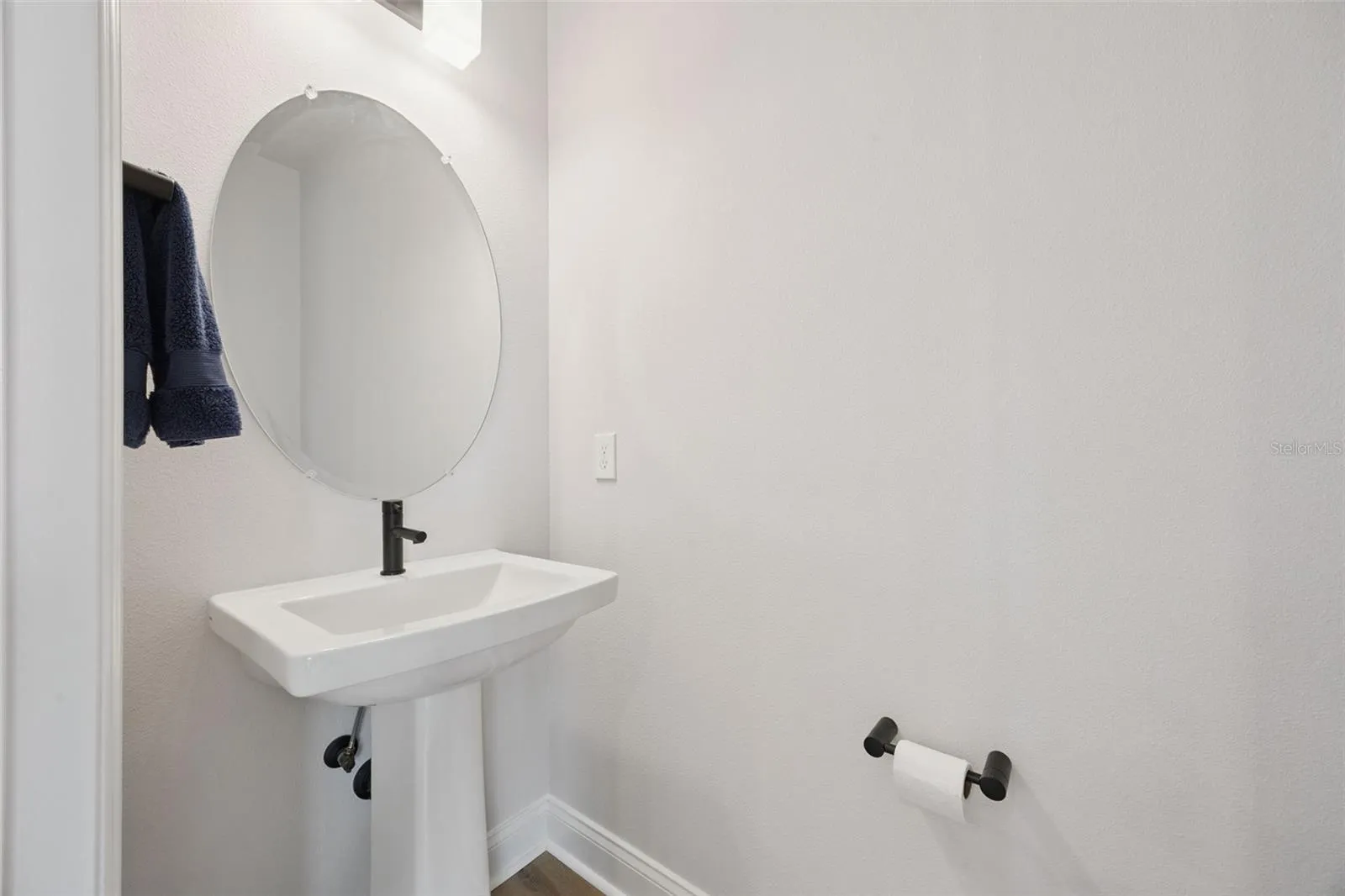 Guest Powder Bath off the Foyer with finer Moen Black Matte Fixtures.