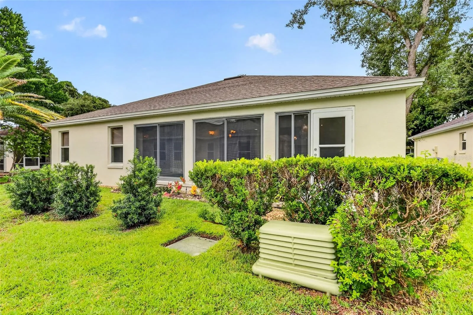 Step outside and enjoy the enhanced privacy provided by the newly planted privacy shrubs just beyond the lanai, creating a peaceful backdrop.