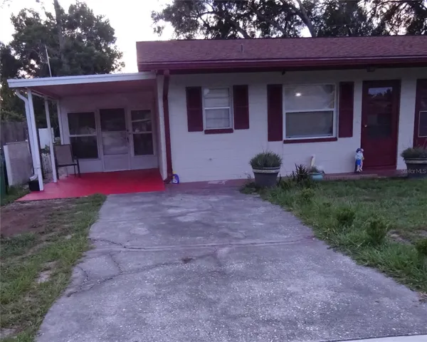 Front of the  unit.  One carport and one parking pad.