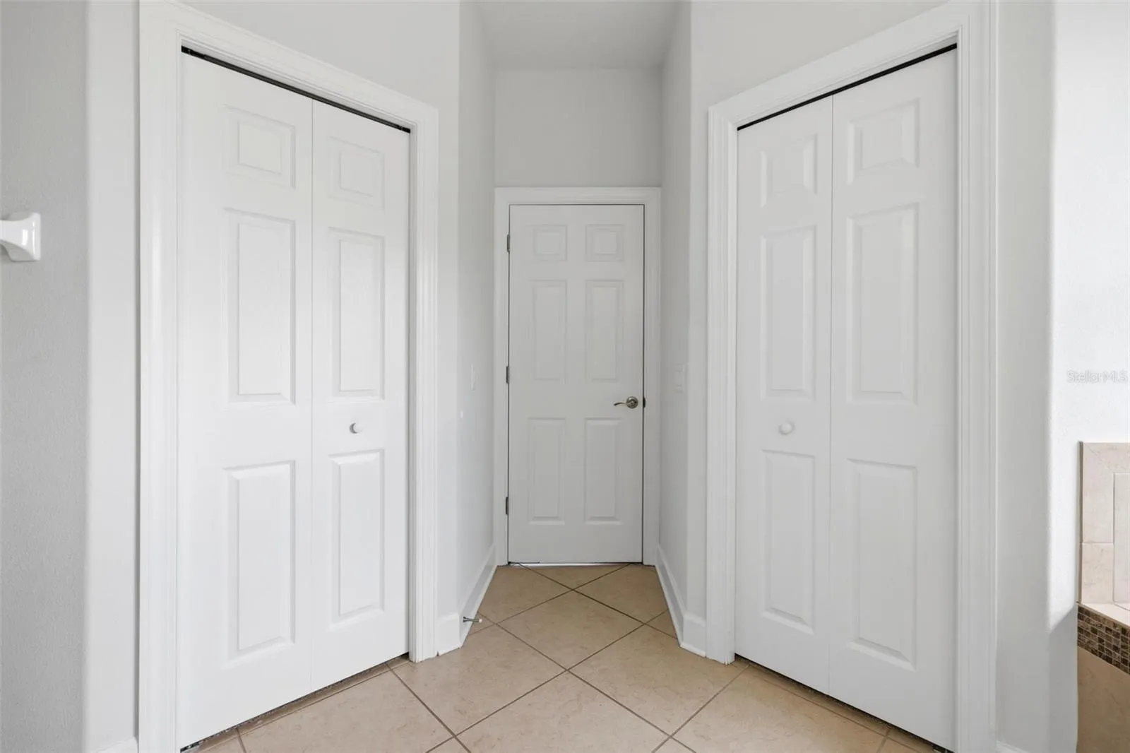Primary Bathroom closets and door to bedroom