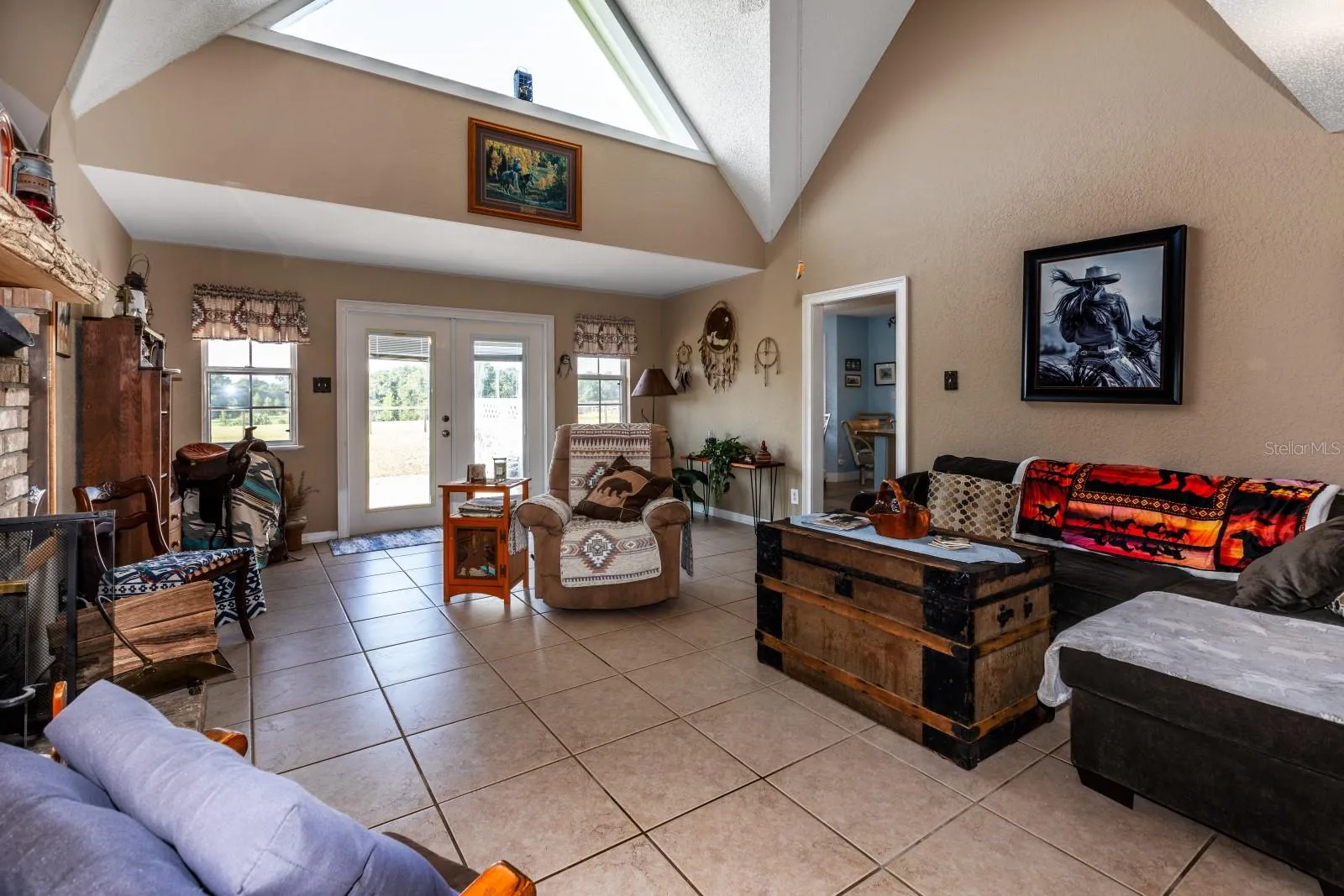 Large, open Living Room with French Doors leading to the back yard