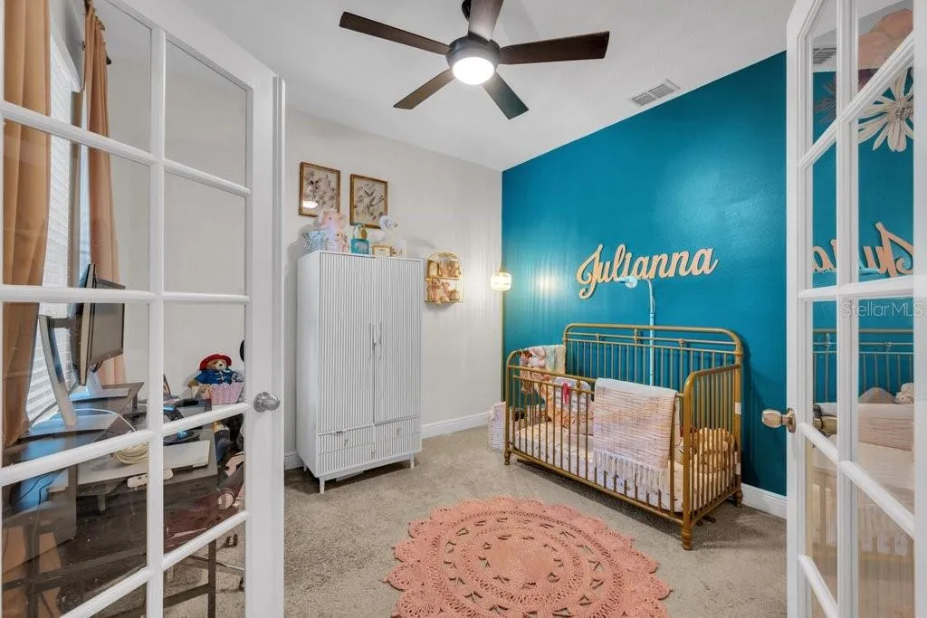 Office being used as office/nursery. French doors and a nice view of outside from the desk.