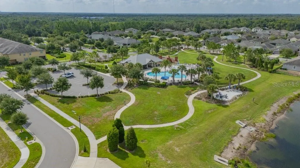 View of the community pool, clubhouse and playground.