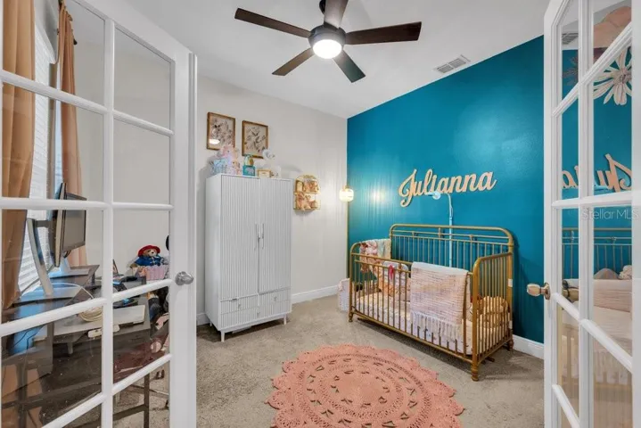 Office being used as office/nursery. French doors and a nice view of outside from the desk.
