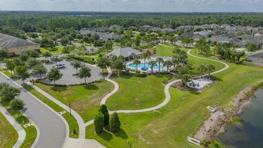 View of the community pool, clubhouse and playground.