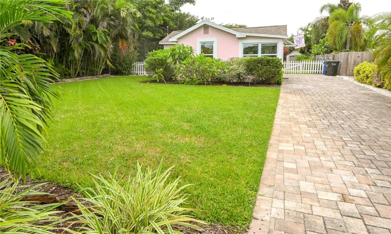 Front exterior with beautiful front yard and paved drive.