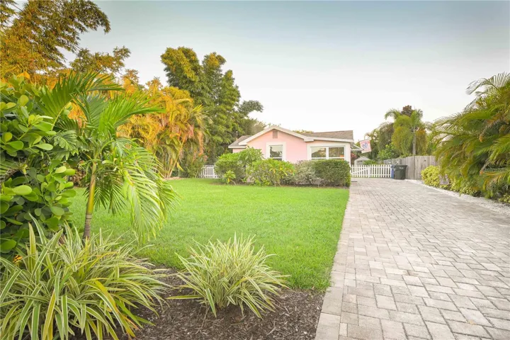 Front exterior with beautiful front yard and paved drive.