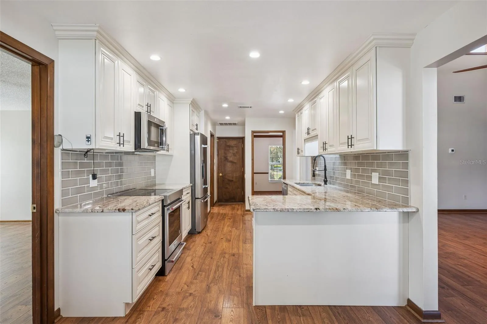 Remodeled Kitchen with Granite Countertops and Stainless Steel Appliances