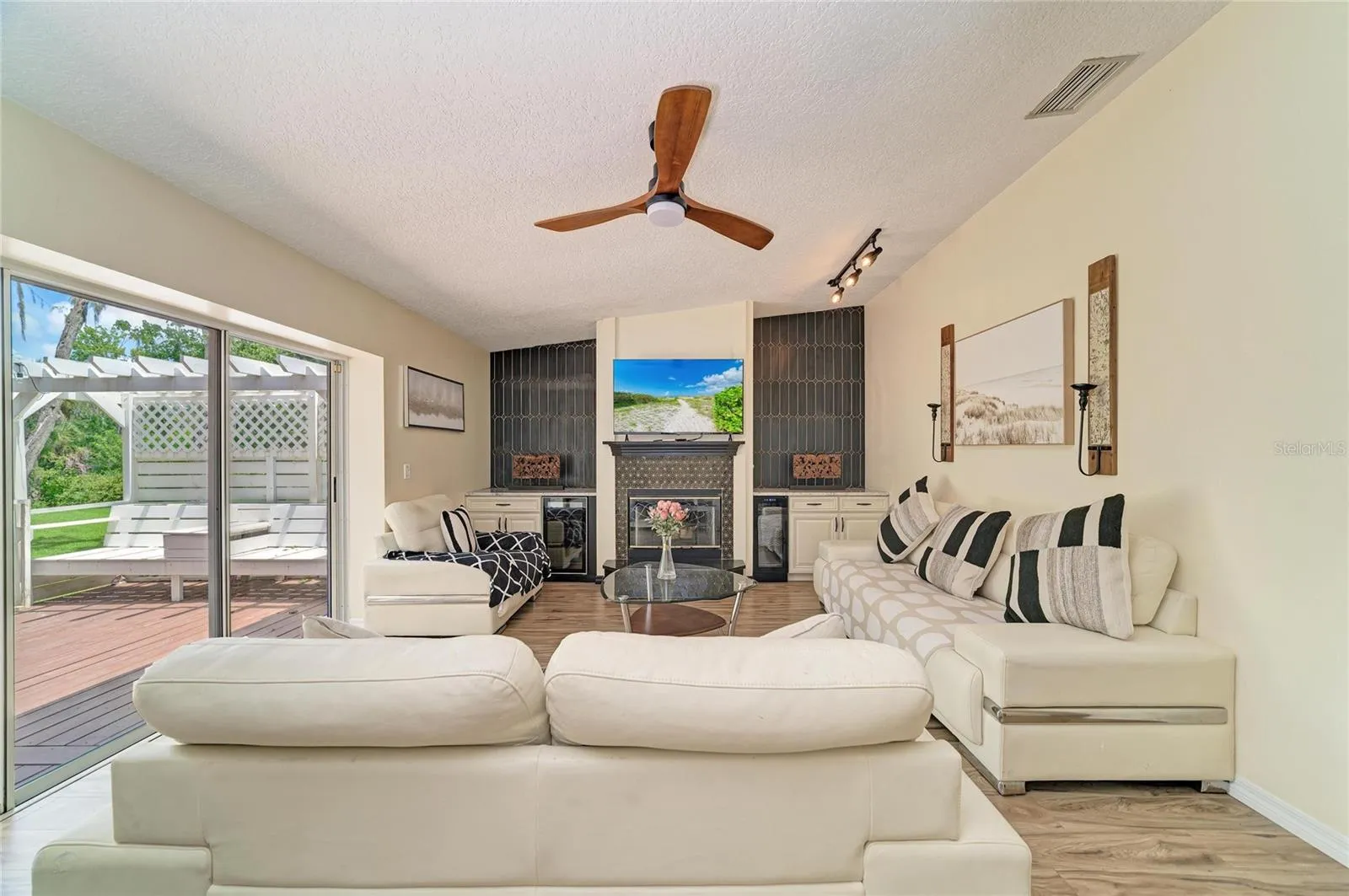 Family room with fireplace, built-in cabinetry, and two mini-fridges.