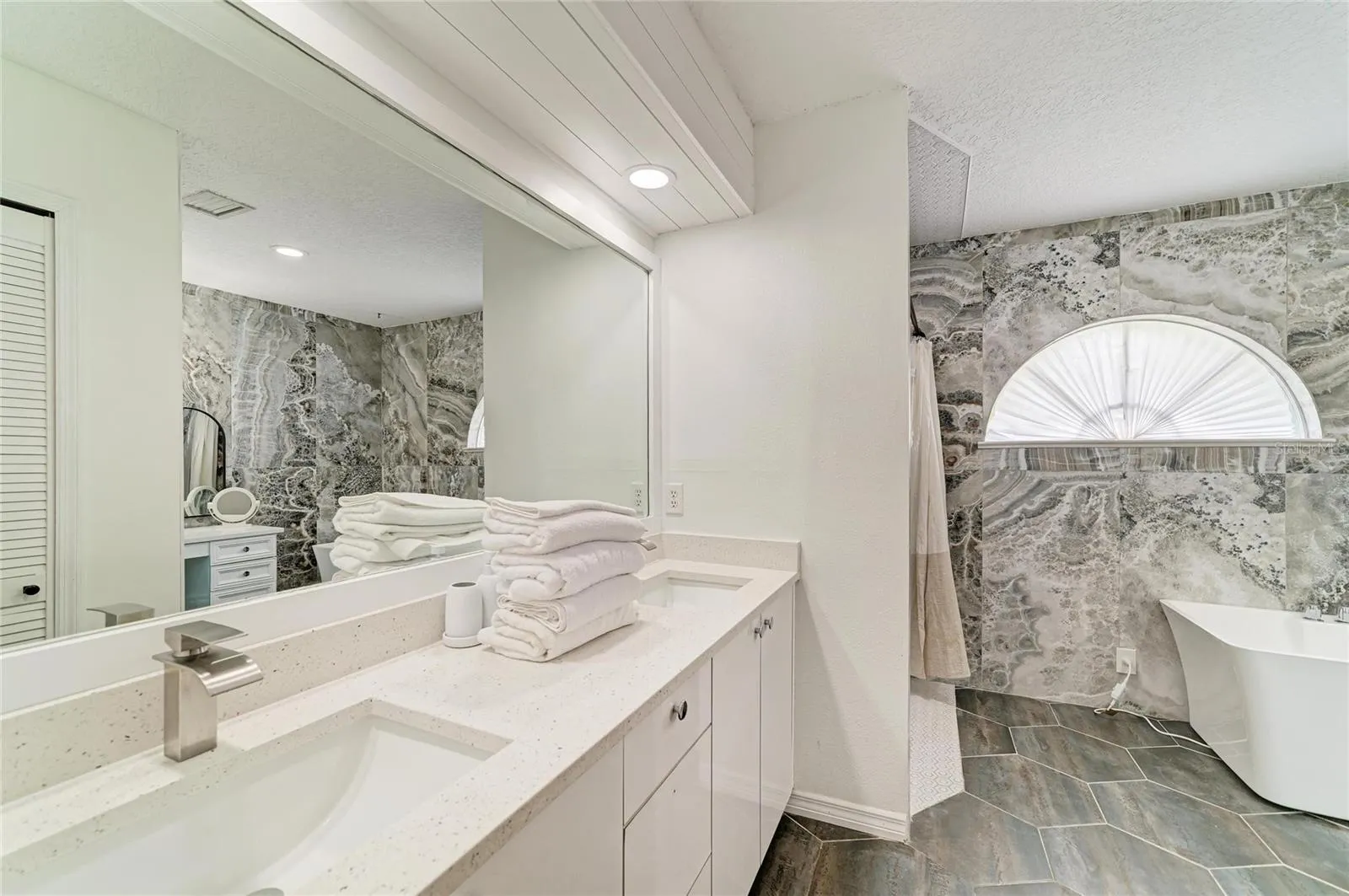 Updated Primary Bathroom with truly beautiful finishes.