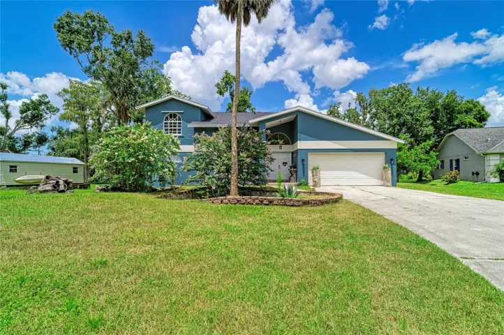 Front exterior of home and beautiful front yard.