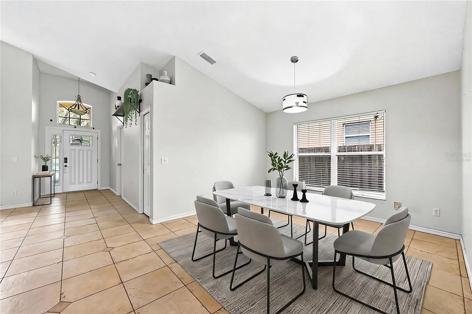 Foyer opens up to versatile formal living and dining spaces. Virtually Staged.