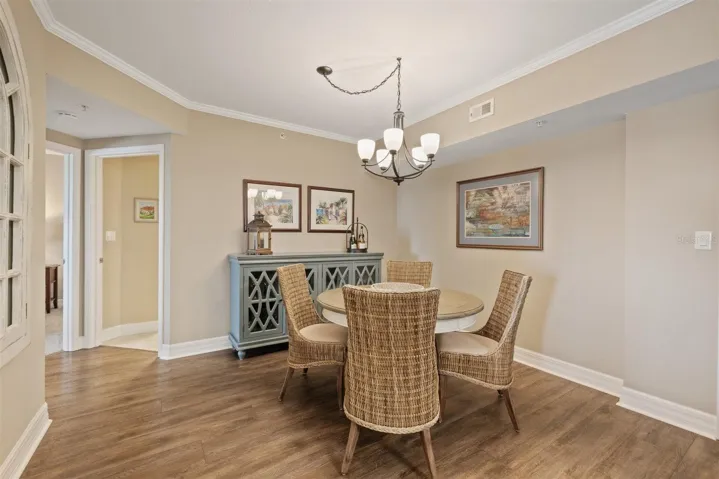 Updated LVT flooring and large dining space with updated light fixture