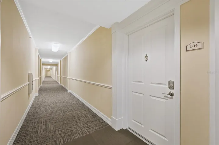 Front door of unit looking toward elevators