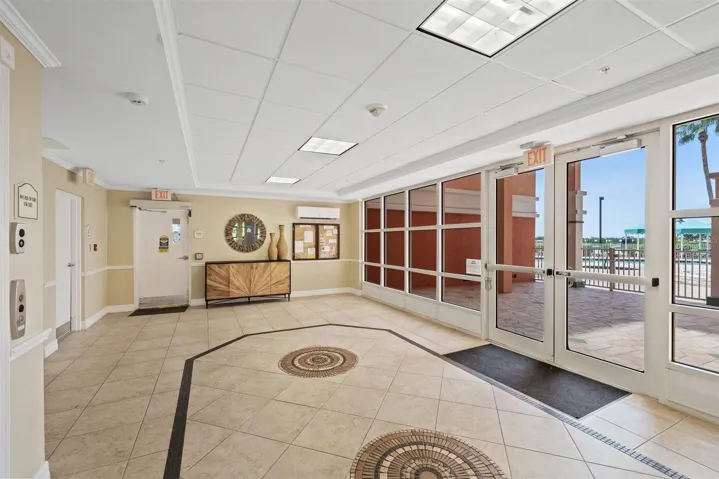 Back entry door and side pool doors in front of two elevators for building.