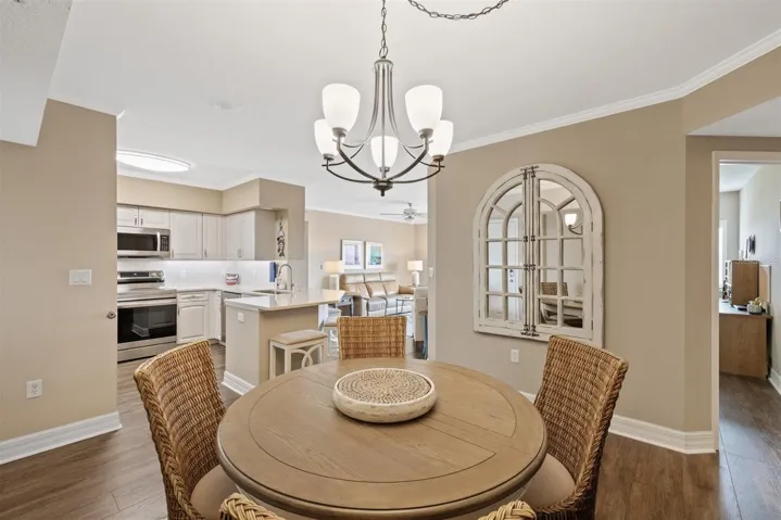 Open living spaces, with view of guest bedroom/office living room, kitchen and dining area