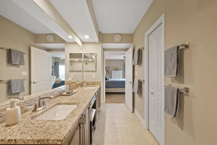 Ensuite bathroom with dual sinks and make-up vanity