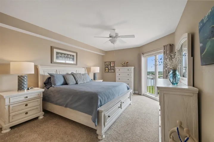Primary suite with sliders to balcony and stunning water views