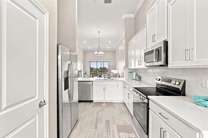 Bright Kitchen Featuring White Cabinetry and Quartz Countertops