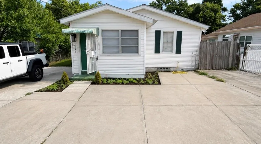 White Bungalow with large Driveway. Digitally enhanced
