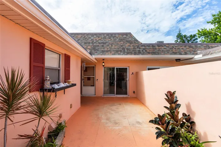 Private front courtyard with garage on the left. Front door and breakfast nook slider ahead.