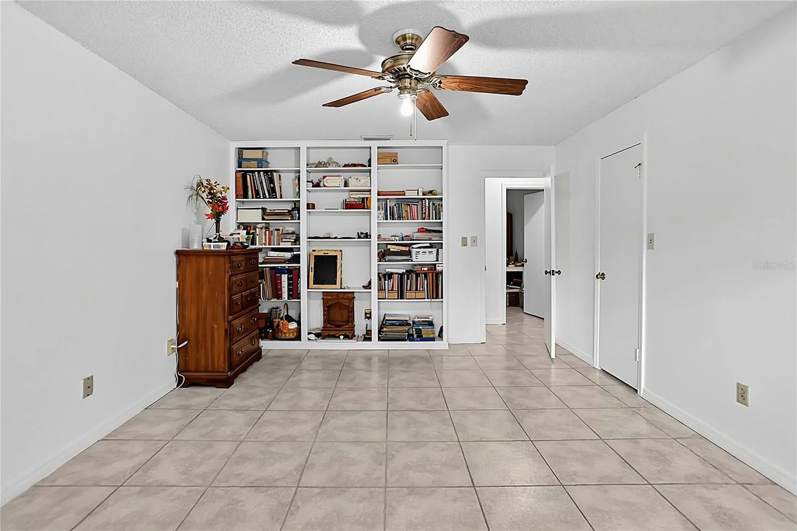 Primary bedroom with built-in shelving.