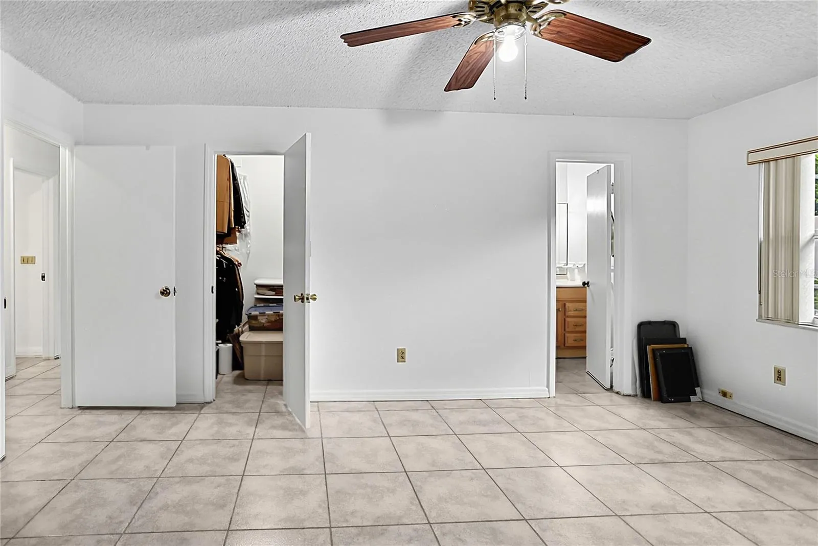 Primary bedroom with walk-in closet and ensuite bathroom.