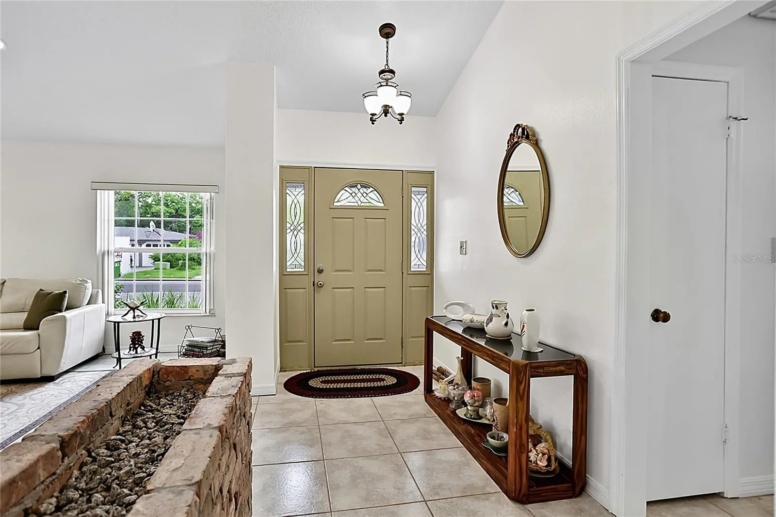 Spacious foyer to welcome your guests and original brick plantar to add character.