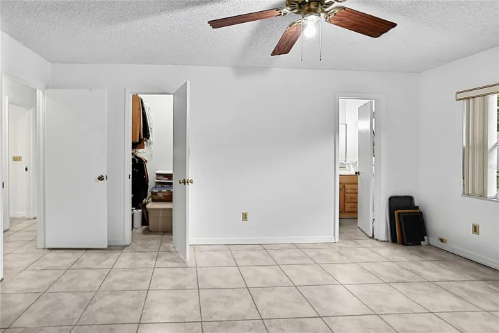 Primary bedroom with walk-in closet and ensuite bathroom.