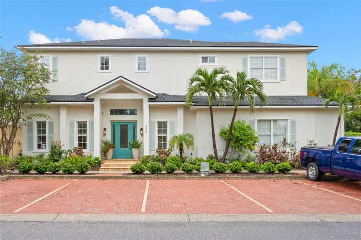 A stately two-story façade, lush tropical landscaping and a cheerful turquoise entry welcome you to this custom-built four-bedroom, three-and-a-half-bath Safety Harbor home.