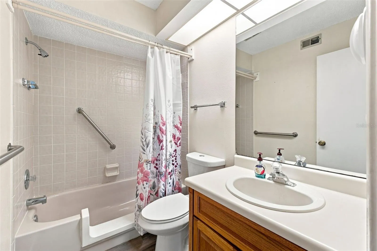 Primary Bathroom with accessible tub shower combo