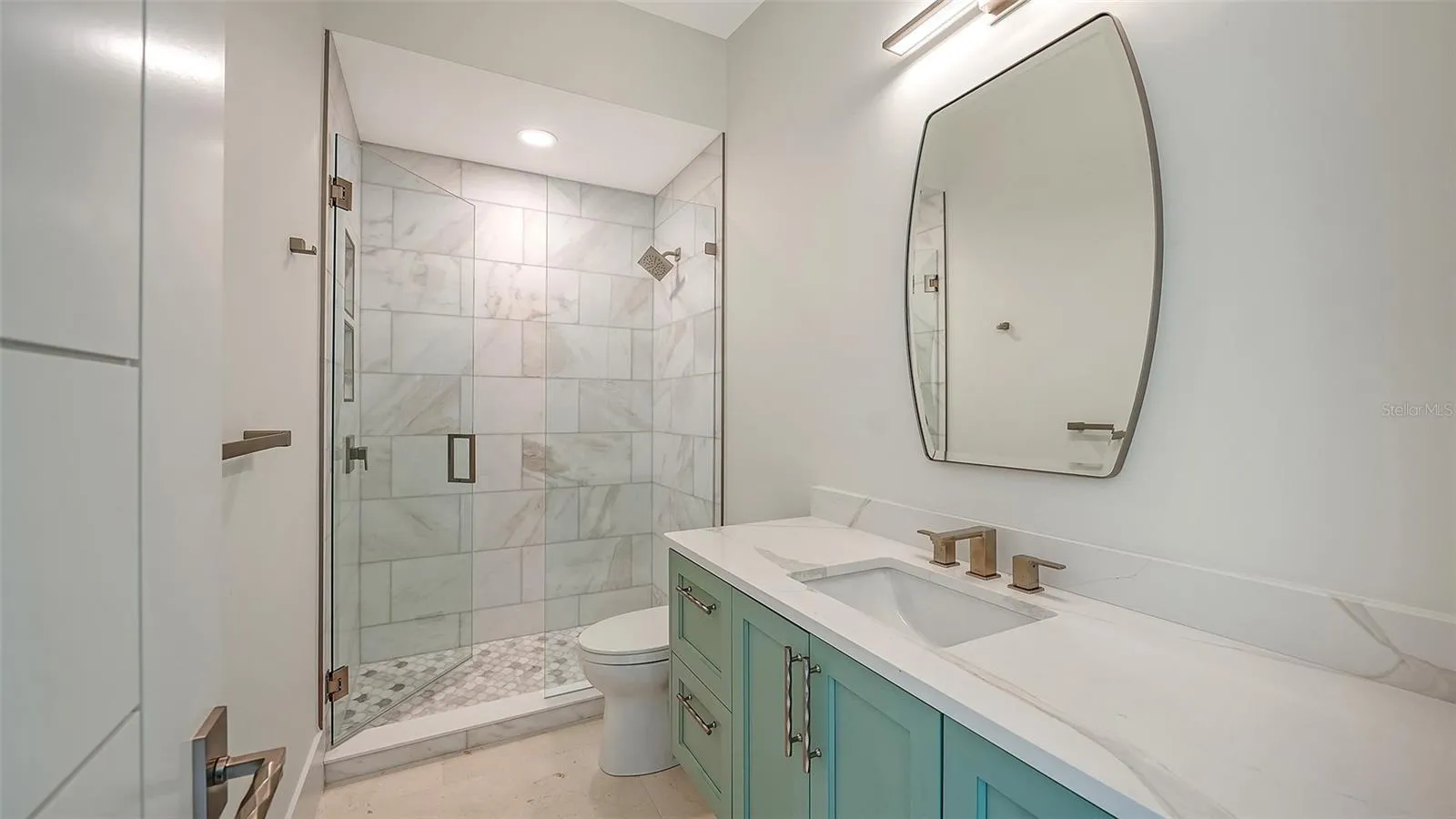 Beautifully appointed with designer finishes and elegant marble accents, this full bath serves both Bedroom 4 and the main living areas, offering comfort and convenience for family and guests alike.