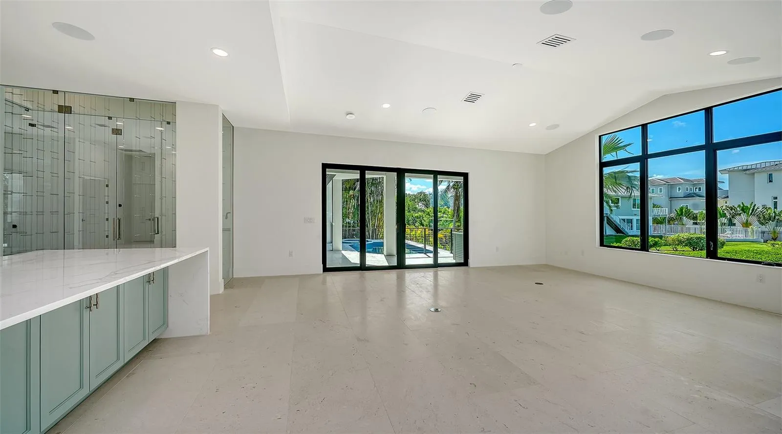 Designed as the heart of the home, the kitchen flows effortlessly into the great room and opens seamlessly to the covered lanai, resort-style pool, and waterfront beyond, creating an exceptional space for everyday living and grand-scale entertaining.