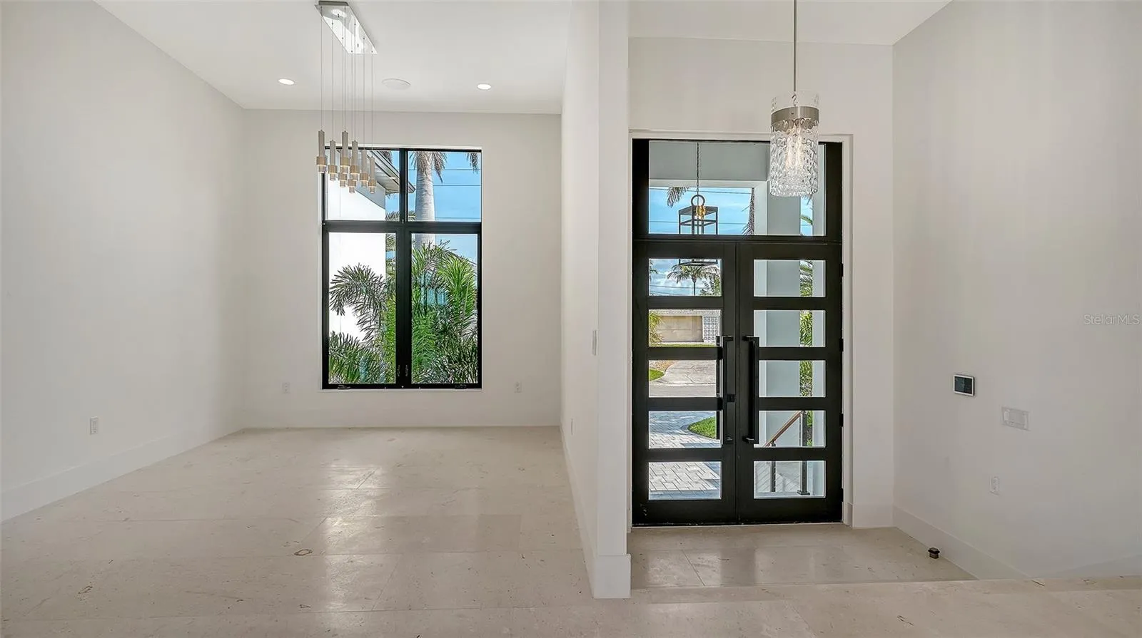 The elegant formal dining room is thoughtfully positioned for both intimate dinners and grand entertaining, seamlessly connecting to the home’s open-concept living spaces.