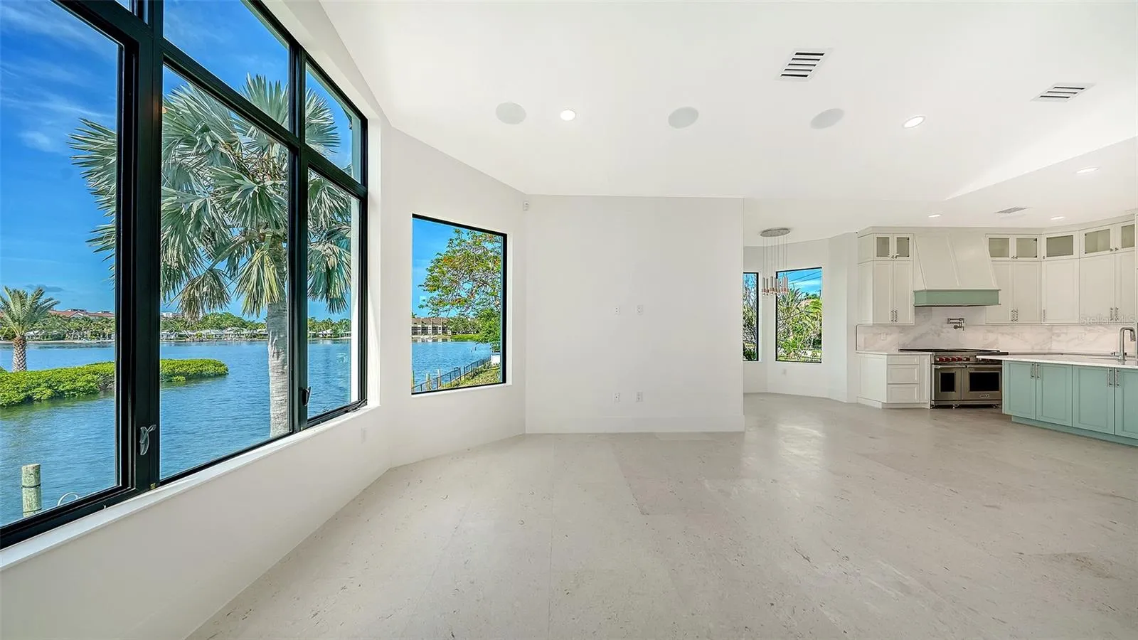 The breakfast area and great room are perfectly positioned to maximize stunning waterfront views, creating an inviting gathering space where natural light and coastal beauty take center stage.